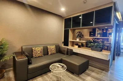 a living room with a couch and a table at SelfCheckIn The State Tower RiverView 2Bedroom BTS ICONSIAM Silom Sathon in Bangkok