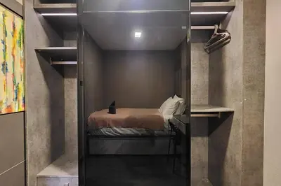 a bedroom with a bed in a small room at SelfCheckIn The State Tower RiverView 2Bedroom BTS ICONSIAM Silom Sathon in Bangkok