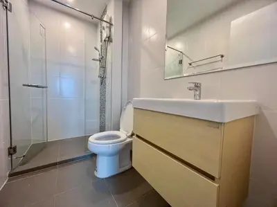 a bathroom with a toilet and a sink and a shower at Metro sky prachachuen in Bang Su