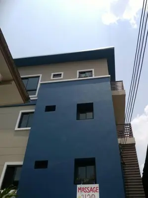 a tall blue building with windows on the side of it at Mimi Cozy Apartment- Old town Siriraj Wanglang Market in Bangkok