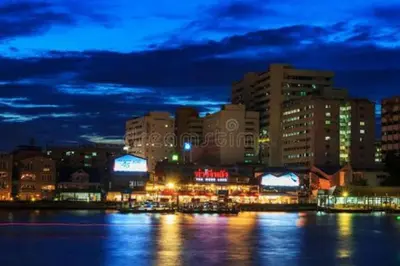 a city lit up at night with buildings and the water at Mimi Cozy Apartment- Old town Siriraj Wanglang Market in Bangkok