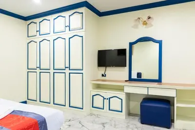 a bedroom with a bed and a mirror at 75 Paradise Lane Managed by Loft Group in Bangkok
