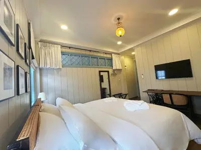 a bedroom with a large white bed in it at Wiengket Heritage 1964 in Bangkok