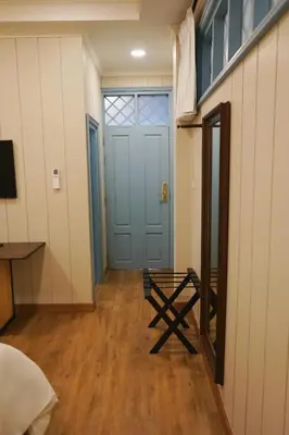 a room with a blue door and a wooden floor at Wiengket Heritage 1964 in Bangkok