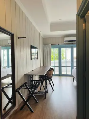 a dining room with a table and chairs in a room at Wiengket Heritage 1964 in Bangkok
