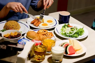 a table full of plates of food with eggs and vegetables at Holiday Inn Express Bangkok Sukhumvit 11 by IHG in Bangkok