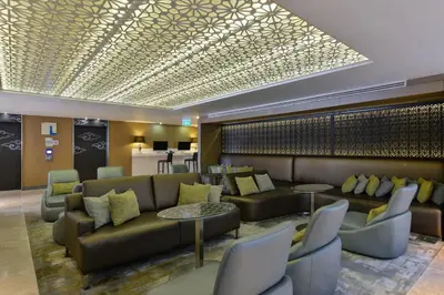 a lobby with a couch and chairs and tables at Holiday Inn Express Bangkok Sukhumvit 11 by IHG in Bangkok