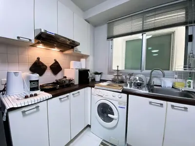 a kitchen with a washing machine and a sink at Spacious 53 SQM - BTS Thong Lo - Ultra Fast WiFi in Khlong Toei