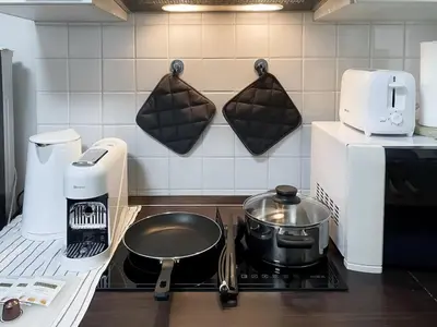 a kitchen with a stove with a pot on it at Spacious 53 SQM - BTS Thong Lo - Ultra Fast WiFi in Khlong Toei