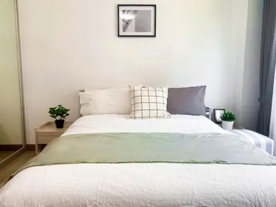 a bedroom with a large bed with white sheets at Spacious 53 SQM - BTS Thong Lo - Ultra Fast WiFi in Khlong Toei