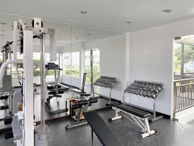 a gym with treadmills and machines in a room at Spacious 53 SQM - BTS Thong Lo - Ultra Fast WiFi in Khlong Toei