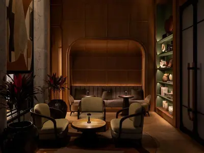 a living room with chairs and a couch and a table at Dusit Thani Bangkok in Bangkok