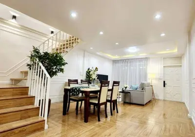 a dining room with a table and chairs and a staircase at Cozy House,4 rooms, bts ,Mega Bangna,Suvarnabhumi in Bangkok
