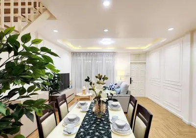 a dining room with a table and a couch at Cozy House,4 rooms, bts ,Mega Bangna,Suvarnabhumi in Bangkok