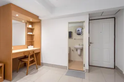 a bathroom with a sink and a toilet at Homies Ratchada Hotel in Bangkok