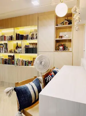 a room with a table and a fan and a book shelf at Single Beds, Private Bath & Balcony, Shared Kitchen with Local Family by Pillows & Purrs in Bangkok