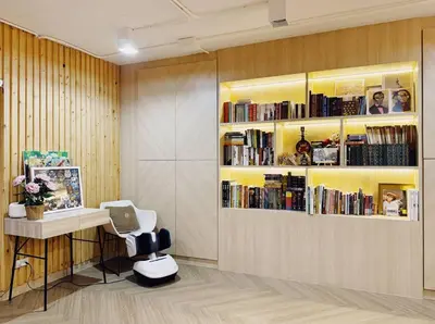 a room with a desk and a book shelf with books at Single Beds, Private Bath & Balcony, Shared Kitchen with Local Family by Pillows & Purrs in Bangkok