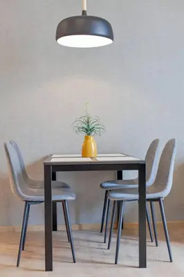 a table with chairs and a vase on top of it at New 2-Bedroom Apartment in Asok in Bangkok