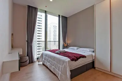 a bedroom with a large bed and a large window at New 2-Bedroom Apartment in Asok in Bangkok