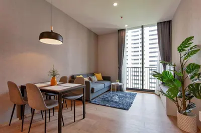 a living room with a table and a couch at New 2-Bedroom Apartment in Asok in Bangkok