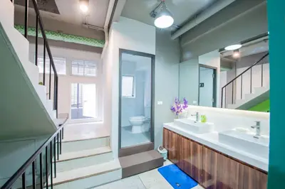 a bathroom with a sink and a toilet at Mascotte Hostel Silom in Bangkok