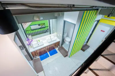 an overhead view of a bathroom with a sink and a mirror at Mascotte Hostel Silom in Bangkok