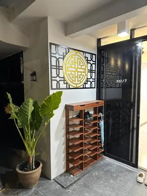 a room with a wine rack next to a door at First Villa Life Hostel in Bangkok