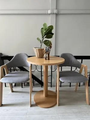 a table with a potted plant on top of it at First Villa Life Hostel in Bangkok