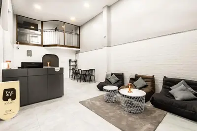 a living room with a couch and a table at The 63rd Hostel in Bangkok
