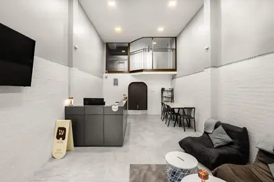 a living room with a couch and a table at The 63rd Hostel in Bangkok