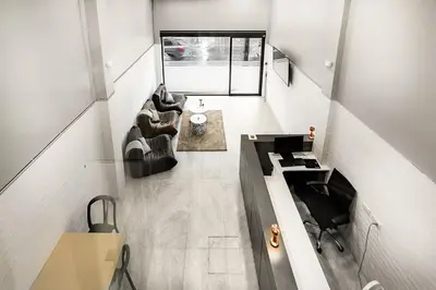 a living room with two chairs and a table at The 63rd Hostel in Bangkok