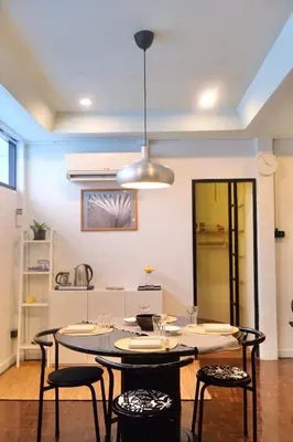 a dining room with a table and some chairs at Spacious Design Loft with Rooftop in Bangkok