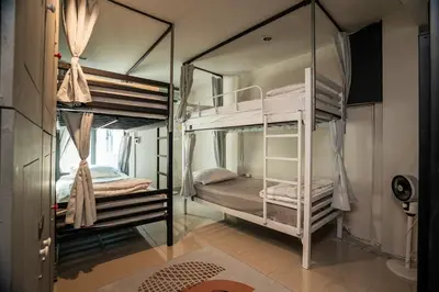 a bedroom with two bunk beds in a room at Bud Brew Beyond Dispensary and Hotel in Bangkok