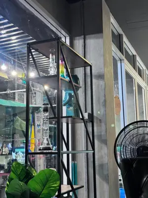 a shelf in a room next to a window at Bud Brew Beyond Dispensary and Hotel in Bangkok
