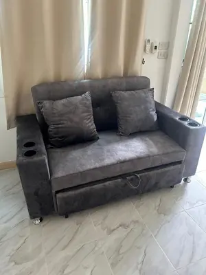 a grey couch sitting in a living room at 93 House in Ban Bang Toei (1)