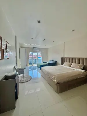 a bedroom with a bed and a desk in it at Baan Farang in Bangkok
