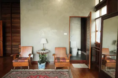 a living room with two chairs and a table at Bannai Bangkoknoi บ้านในบางกอกน้อย in Ban Bang Bamru