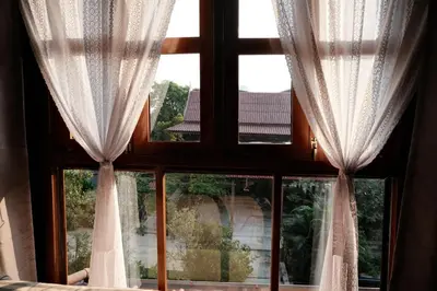 a window with white curtains and a view at Bannai Bangkoknoi บ้านในบางกอกน้อย in Ban Bang Bamru