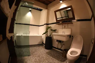 a bathroom with a sink and a toilet and a tub at Baanrongmai Canal Front Homestay in Bang Chak