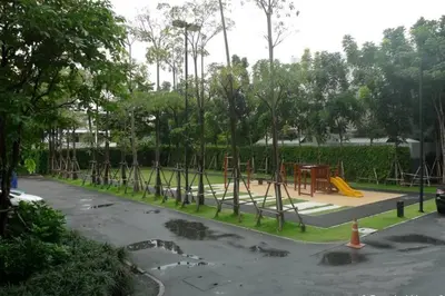 a park with a playground with a yellow slide at 1 Bedroom near MRT & BTS station. in Bangkok