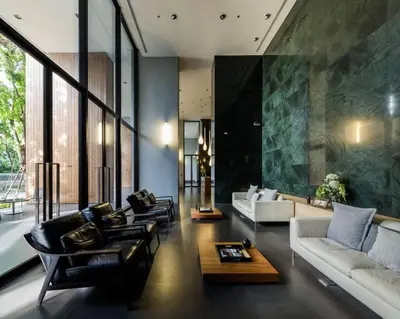 a large living room with couches and a table at 1 Bedroom near MRT & BTS station. in Bangkok