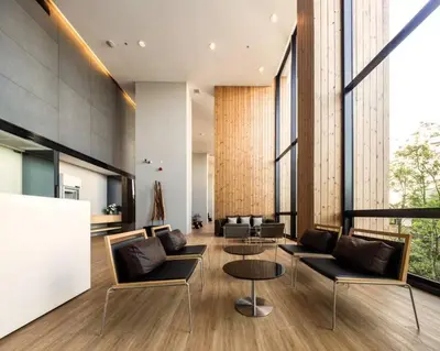 a lobby with couches and tables and large windows at 1 Bedroom near MRT & BTS station. in Bangkok