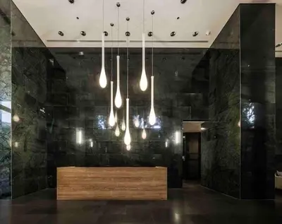 a lobby with a wooden bench and lights at 1 Bedroom near MRT & BTS station. in Bangkok