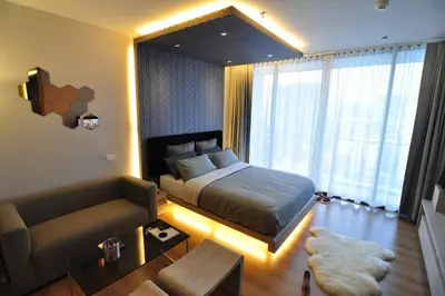 a bedroom with a bed and a couch in it at 1 Bedroom near MRT & BTS station. in Bangkok