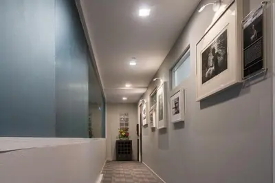 a hallway with framed pictures on the walls at Aspira Suites Sukhumvit 20 in Bangkok