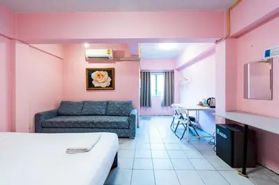 a room with a bed and a couch and a table at xx GO INN The Grand Palace โกอินน์ MRT สามยอด in Bangkok