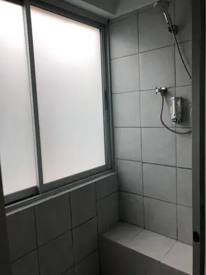 a bathroom with a shower with a window at Revolution Khao San by The Bliss in Bangkok