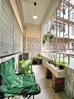 a balcony with a chair and potted plants on it at Cozy Gallery Studio at Chinatown in Bangkok