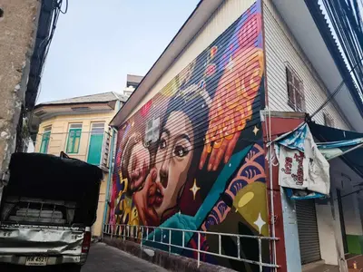 a mural of a woman on the side of a building at Cozy Gallery Studio at Chinatown in Bangkok