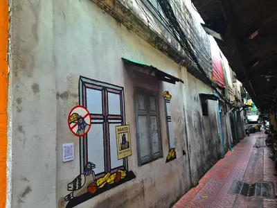 a building with a painting on the side of it at Cozy Gallery Studio at Chinatown in Bangkok